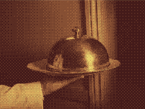 A waiter holding a polished metal serving dome.